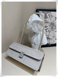 Close-up of luxury silver rhinestone handbag with sparkling crystal details and chain