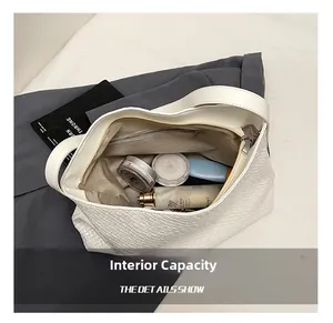 Top-down detail showing internal capacity of white woven tote bag with cosmetics