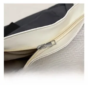 Close-up of premium silver zipper and woven texture on a minimalist tote bag