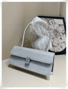 Macro detail of silver rhinestone evening bag with sparkling gems and metal buckle