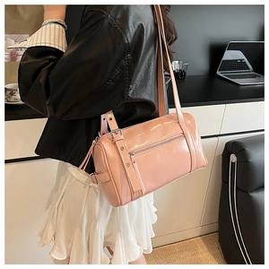 Detail of pink mirror patent leather pillow bag with silver zippers and metal hardware