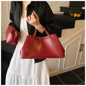 Detail of red leather tote bag set including large handbag and small zipper pouch