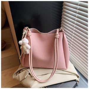 Détail du sac cabas rose en cuir grainé avec breloque ours et lanières nouées