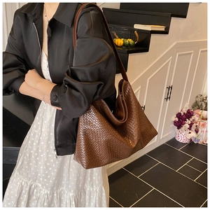 Detail of dark brown woven leather hobo shoulder bag with large capacity and matte finish
