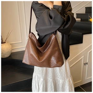Close-up of brown woven texture hobo bag with large capacity for stylish commuting style