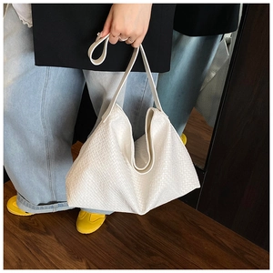 Detailed view of white woven texture on a minimalist large capacity tote bag