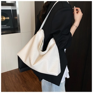 Detailed view of the white woven PU leather texture on a large shoulder tote bag