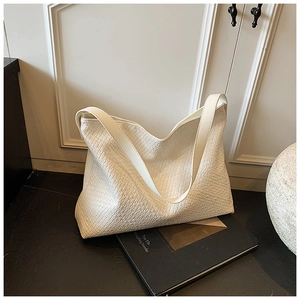 Close-up of white woven leather texture on a large minimalist tote bag for daily commute