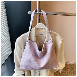 Detailed view of light purple tote bag with premium woven leather texture for office commute
