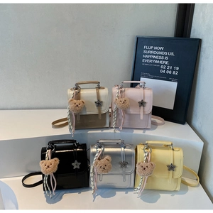 Detailed view of fashionable square bags in 5 colors with star buckles and plush bears