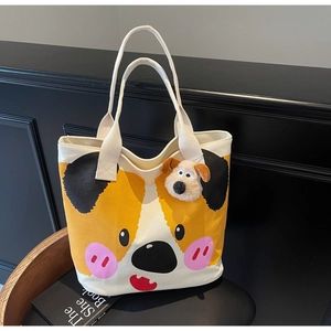 Detail der weißen Canvas-Einkaufstasche mit Cartoon-Corgi-Print und Plüsch-Hundeanhänger