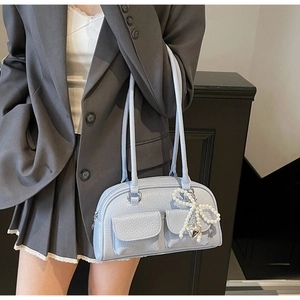 Detail of light blue bowling bag with lychee texture and pearl bow heart charm
