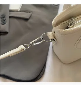 Detailed macro view of lychee pattern leather bucket bag with shiny silver hardware accents