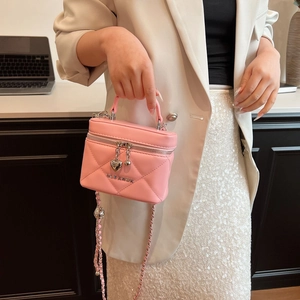 Pink quilted leather vanity bag with heart pendants and silver chain strap