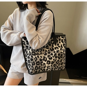 Detail view of leopard print tote bag with black trim and handles for daily styling