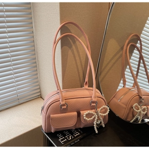Pink lychee texture bowling bag with front flap pockets and pearl bow heart charm