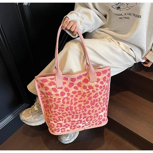 Detail of pink leopard print canvas tote bag with reinforced handles for women