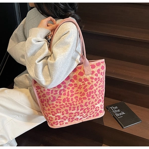 Detail of large tote bag with pink and orange leopard print and rope handles