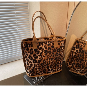 Macro detail of leopard print tote bag fabric and woven brown shoulder straps