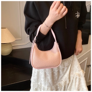 Detail of pink croc-effect hobo bag showing textured leather finish and crescent shape