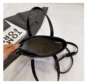 Close-up of black straw bucket bag interior with grey lining and white lace detail