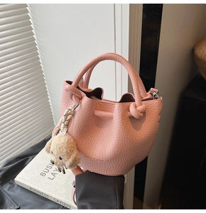 Pink lychee grain leather bucket bag with top handles and cute teddy bear charm