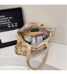 Interior view of large canvas tote bag showing storage space for laptop and water bottle