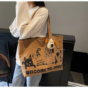 Large canvas tote bag featuring cartoon animal prints and a plush puppy pendant