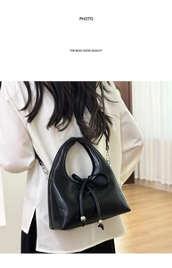 Detail of black moon hobo bag with a decorative bow knot and metallic bead accents