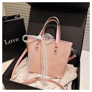 Detailed view of pink woven tote bag with lace bow and adjustable PU strap in gift box