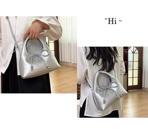 Close-up of metallic silver crescent bag with bow detail and beaded drawstring accents