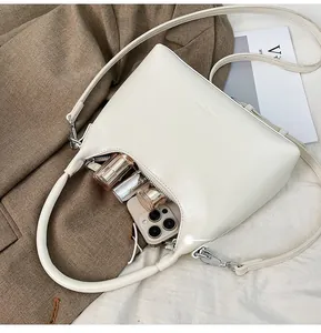 Top view of cream leather crescent bag showing interior space for phone and makeup
