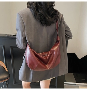 Detailed back view of a burgundy oversized crescent shoulder bag in soft leather finish