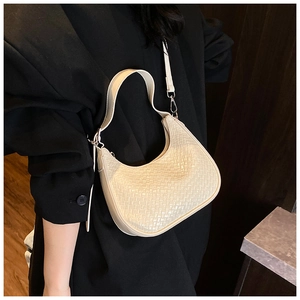 Detail of off-white woven texture and sleek zipper on this trendy crescent hobo bag