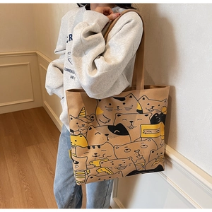 Detail of large canvas tote bag with cartoon cat prints and comfortable wide shoulder strap