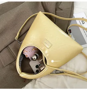 Detail view of the spacious inner compartment of the yellow crescent underarm bag