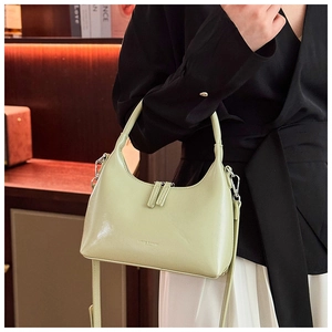 Detailed view of light green hobo bag with smooth synthetic leather and silver hardware