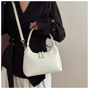 Close-up of white wax leather dumpling bag with double zippers and brand lettering