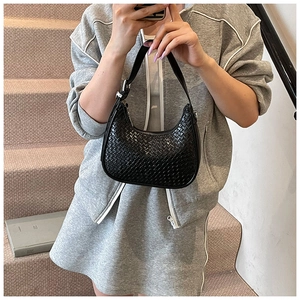 Close-up of black woven leather hobo bag with adjustable silver buckle strap