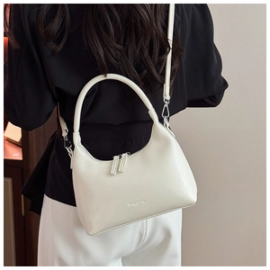 Detail of off-white crossbody saddle bag with smooth PU leather finish and shoulder strap