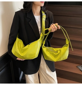 Detailed comparison of two lime green crescent crossbody bags in large and small sizes