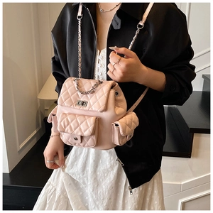 Detail of light pink quilted mini backpack with silver metal chain and twist lock