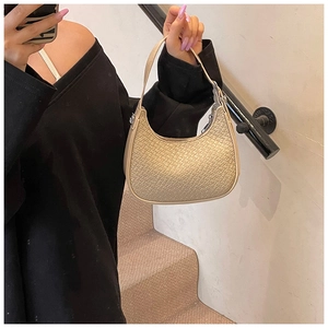Detailed macro view of beige crescent hobo bag with high-quality crocodile skin texture
