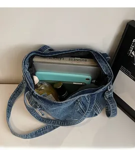 Macro view of blue denim tote bag interior showing large capacity for laptops and books