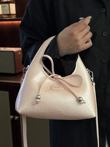 Pink pearl gloss crescent baguette bag with bow detail and slim shoulder strap