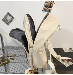 Detail of cream travel backpack with large main compartment and side water bottle pocket