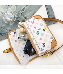 Detailed interior of a white monogram messenger bag showing spacious storage capacity