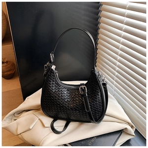 Detail of black woven hobo shoulder bag with silver zipper and textured finish