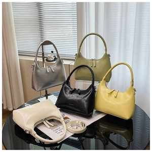 Detailed view of half-moon underarm bags in silver, olive, black, yellow and cream