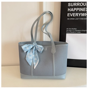 Détail du sac cabas bleu clair en mesh avec bordure en similicuir et foulard à coeurs